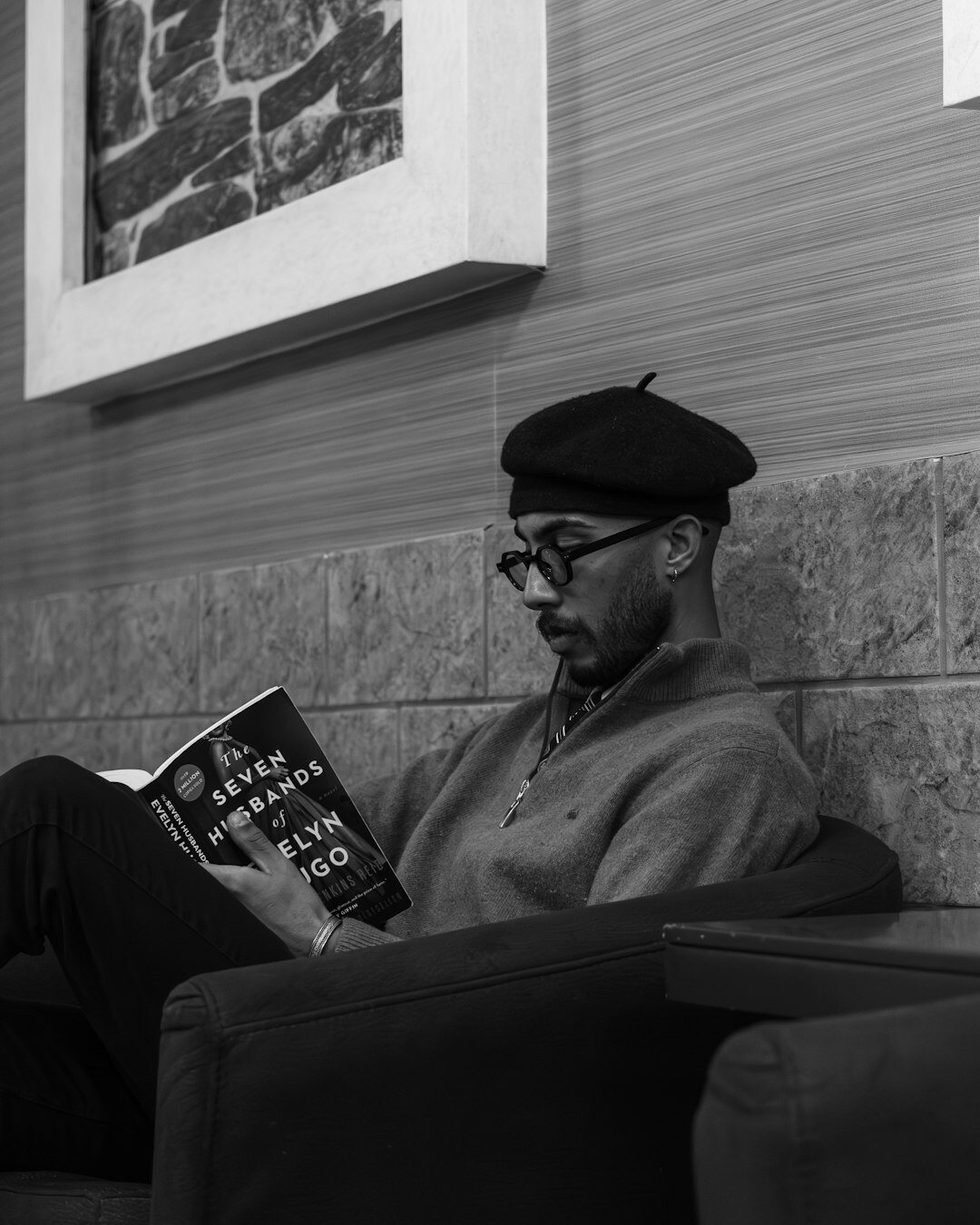 Croatian author sitting in armchair reading his own novel